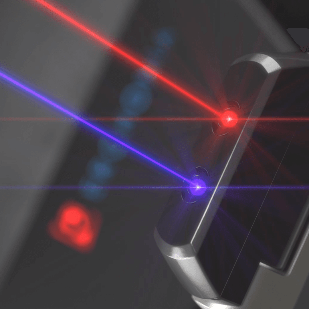 Close-up of a device emitting red and blue laser beams in a dark environment.